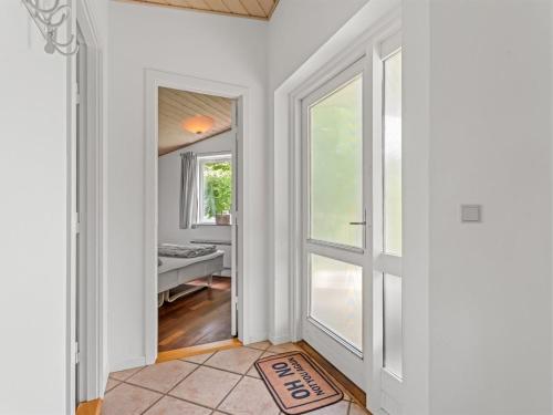 an empty hallway with a door and a window at Holiday Home Allie - 150m from the sea by Interhome in Rødby