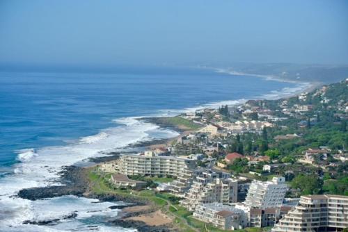 an aerial view of a beach with buildings and the ocean at Ballito Sands in Ballito