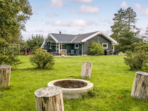a house with a fire pit in the yard at Holiday Home Stasia - 75m from the sea by Interhome in Middelfart