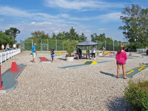 a group of people playing in a playground at Holiday Home Stasia - 75m from the sea by Interhome in Middelfart