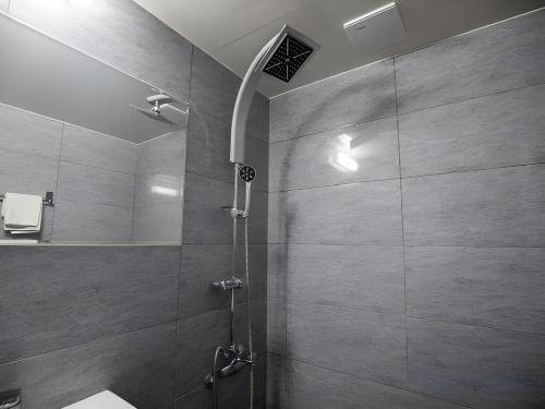 a bathroom with a shower with a glass door at 제주토비스콘도 신관 in Kwakchi-ri