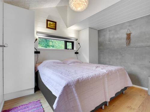 a bedroom with a bed and a window at Holiday Home Gunborg - 400m from the sea by Interhome in Sjølund