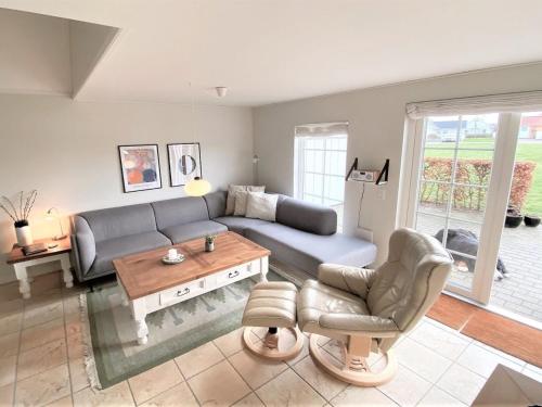 a living room with a couch and a table at Holiday Home Eike - 250m from the sea by Interhome in Bro
