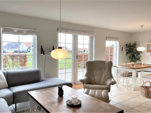 a living room with a couch and a table at Holiday Home Eike - 250m from the sea by Interhome in Bro