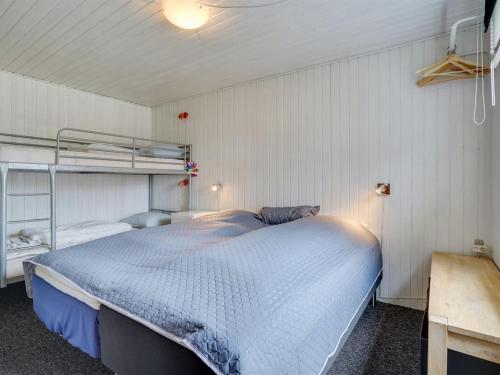 a bedroom with a bed and a bunk bed at Holiday Home Sigurd - 20m from the sea by Interhome in Middelfart