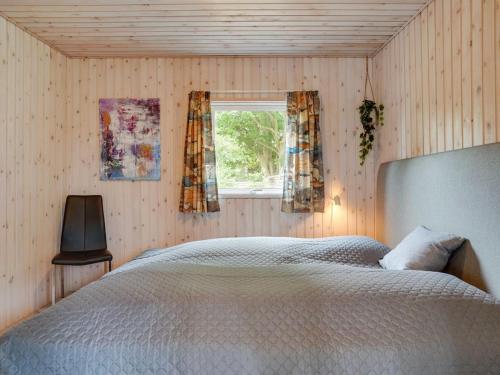 a bedroom with a large bed and a window at Holiday Home Sigurd - 20m from the sea by Interhome in Middelfart