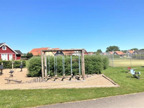 a park with a playground with a batting cage at Holiday Home Bleike - 250m from the sea by Interhome in Bro
