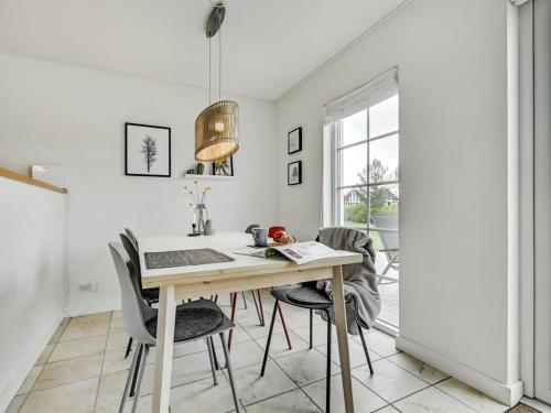a dining room with a table and chairs at Holiday Home Bleike - 250m from the sea by Interhome in Bro