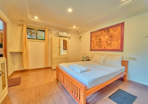 a bedroom with a large bed in a room at Kedara Resort Wayanad by VOYE HOMES in Sultan Bathery