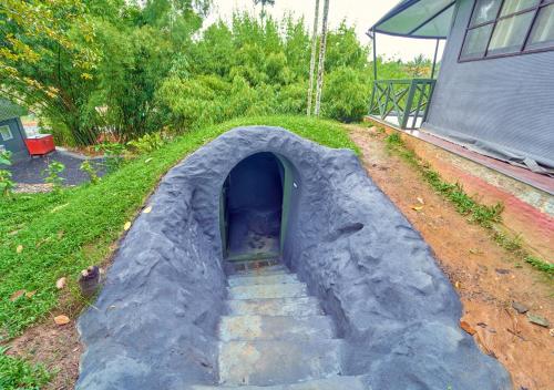 a play tunnel with stairs leading into a house at Kedara Resort Wayanad by VOYE HOMES in Sultan Bathery