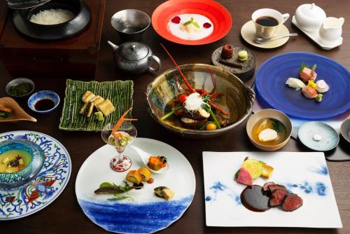 a wooden table with plates of food on it at 富士青藍 in Numazu