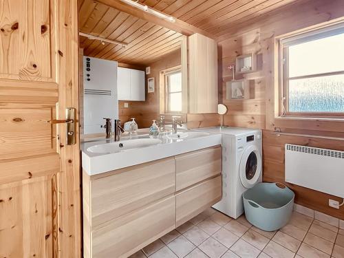 a bathroom with a sink and a washing machine at Holiday Home Stacie - 10m from the sea by Interhome in Gedser