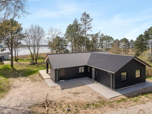 a house with a black roof at Holiday Home Haley - 150m from the sea by Interhome in Millinge