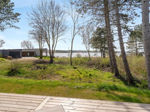 a house with a view of the water and trees at Holiday Home Haley - 150m from the sea by Interhome in Millinge