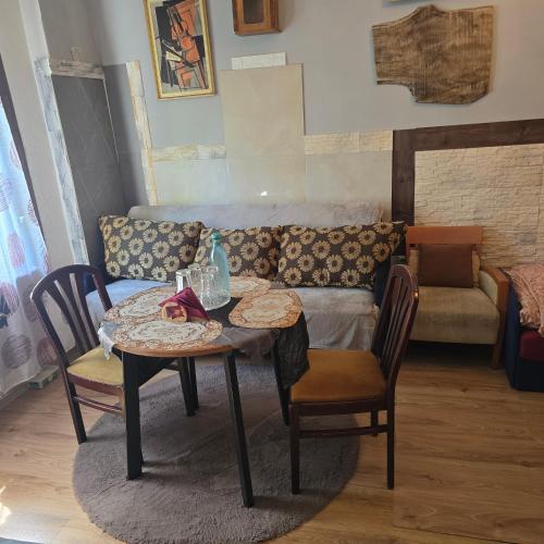 a living room with a table and a couch at Hostel Apollo in Ząbkowice Śląskie