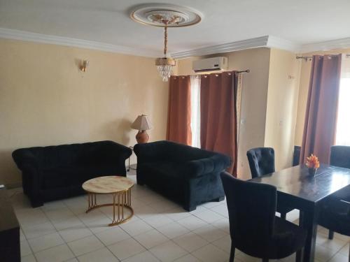 a living room with two couches and a table at Complexe WAB in Douala