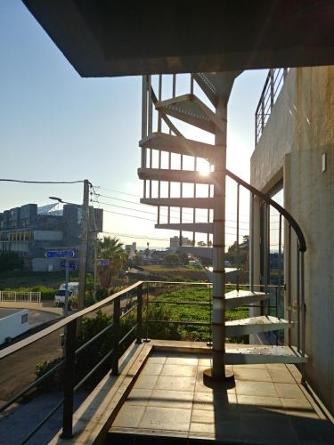 a balcony of a building with stairs on it at Oh Happy Day Jeju in Jeju
