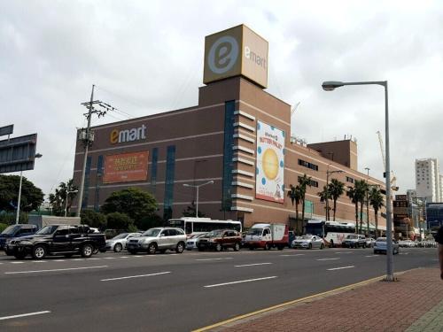a building with a clock tower on the side of a street at Oh Happy Day Jeju in Jeju