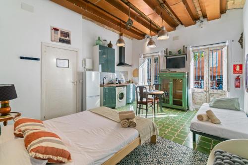 a room with two beds and a kitchen at Barcelona Studios with private kitchen, toilet & shower 20min from the center 5min to the beach in Sant Adria de Besos