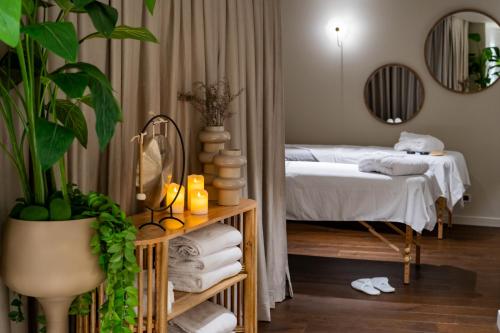 a bedroom with a bed and a table with towels at Fiori 41-By Adam Hotels in Tel Aviv