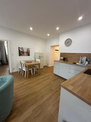 a kitchen and a dining room with a table and a counter at Apartmány Tachov in Tachov