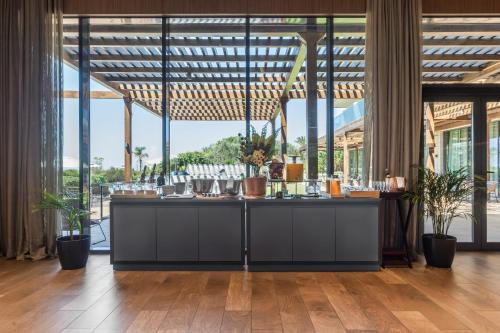 a bar in a large room with windows at Eurostars Cascais in Cascais