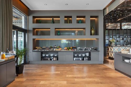 a restaurant with a counter with food on display at Eurostars Cascais in Cascais
