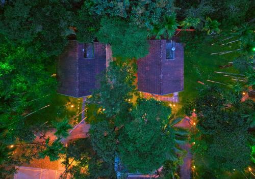 an overhead view of a house with trees and lights at Kedara Resort Wayanad by VOYE HOMES in Sultan Bathery