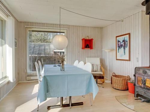 a dining room with a blue table and chairs at Holiday Home Kalle - 400m from the sea by Interhome in Hårby