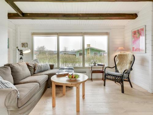 a living room with a couch and a table at Holiday Home Ylvie - 150m from the sea by Interhome in Frørup