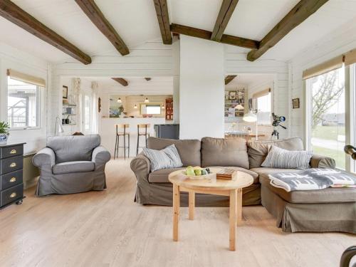 a living room with a couch and a table at Holiday Home Ylvie - 150m from the sea by Interhome in Frørup