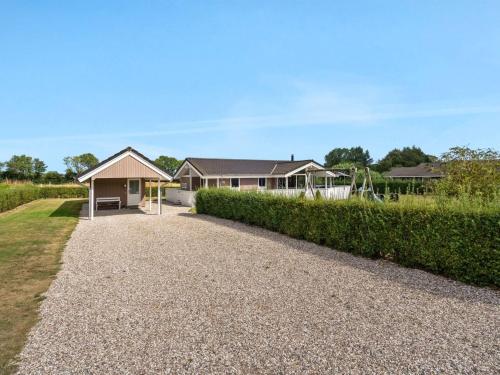 a house with a gravel driveway at Holiday Home Stefanka - 600m from the sea by Interhome in Spodsbjerg