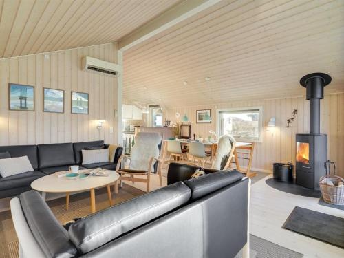 a living room with a couch and a fireplace at Holiday Home Kulben - 450m from the sea by Interhome in Frørup