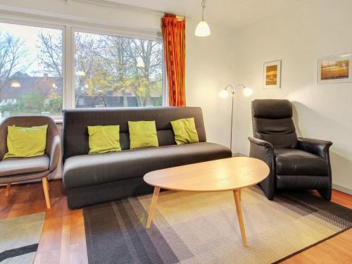a living room with a couch and two chairs and a table at Holiday Home Claudia by Interhome in Bredebro