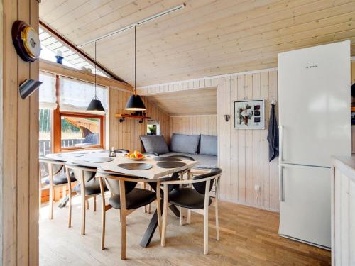 a kitchen and dining room in a tiny house at Holiday Home Ela - 500m from the sea by Interhome in Spodsbjerg