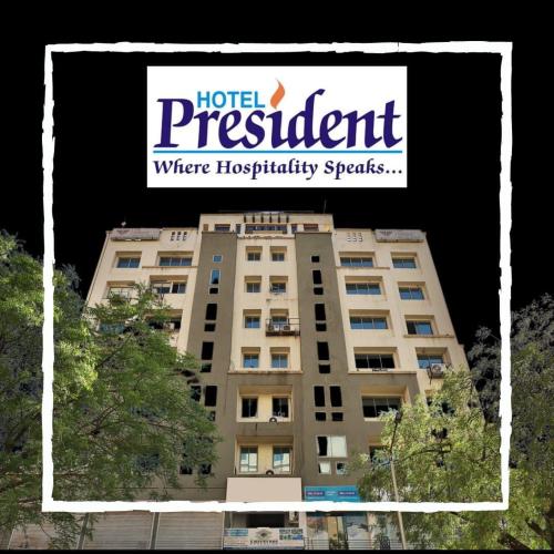 a sign on top of a hotel apartment building at Hotel President Inn, Gandhinagar in Gandhinagar