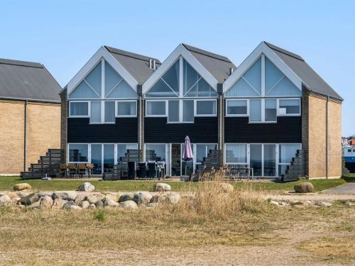 a large black building with a lot of windows at Apartment Ninne - 50m from the sea by Interhome in Assens