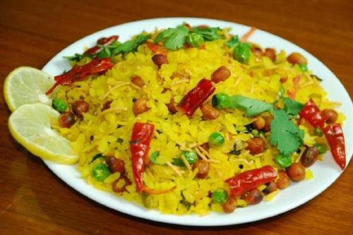 a plate of rice with beans and vegetables on a table at Hotel President Inn, Gandhinagar in Gandhinagar