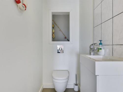 a bathroom with a toilet and a sink at Apartment Henne - 2-5km from the sea by Interhome in Humble