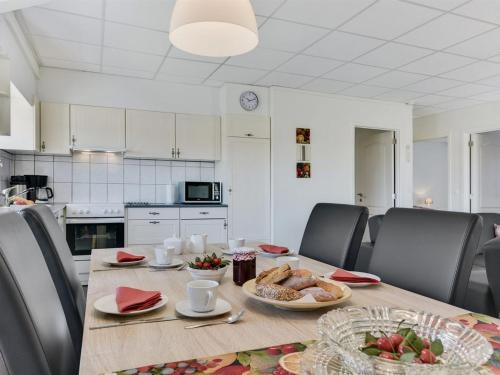 a dining room with a table with food on it at Apartment Henne - 2-5km from the sea by Interhome in Humble