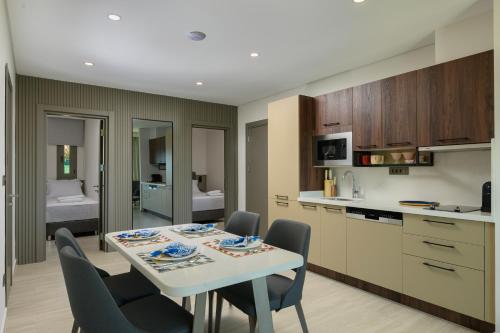 a kitchen and dining room with a table and chairs at Ayaz Suites in Bodrum City