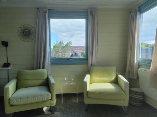 two chairs sitting in a room with a window at Lillebu in Strand