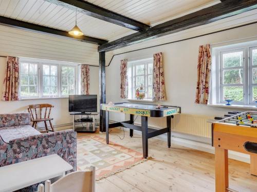 a living room with a ping pong table in it at Holiday Home Hedda - 15km from the sea by Interhome in Ballum