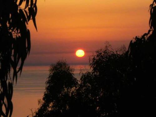 a sunset with the sun in the sky at Villa Panorama in Zambrone