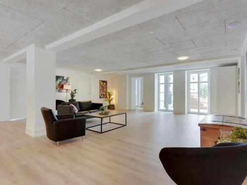 a living room with couches and a table at Holiday Home Guthorm by Interhome in Højer