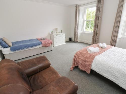 a bedroom with a couch and a bed and a chair at Georgian Town House in Whitehaven