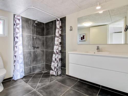 a bathroom with a shower and a toilet and a sink at Holiday Home Yakari - 300m from the sea by Interhome in Haderslev