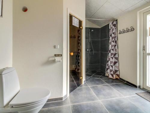 a bathroom with a toilet and a shower at Holiday Home Yakari - 300m from the sea by Interhome in Haderslev