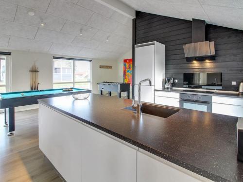 a kitchen with a sink and a pool table at Holiday Home Yakari - 300m from the sea by Interhome in Haderslev