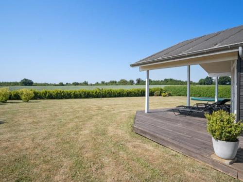 a pavilion with a picnic table on a wooden deck at Holiday Home Iorund - 550m from the sea by Interhome in Haderslev